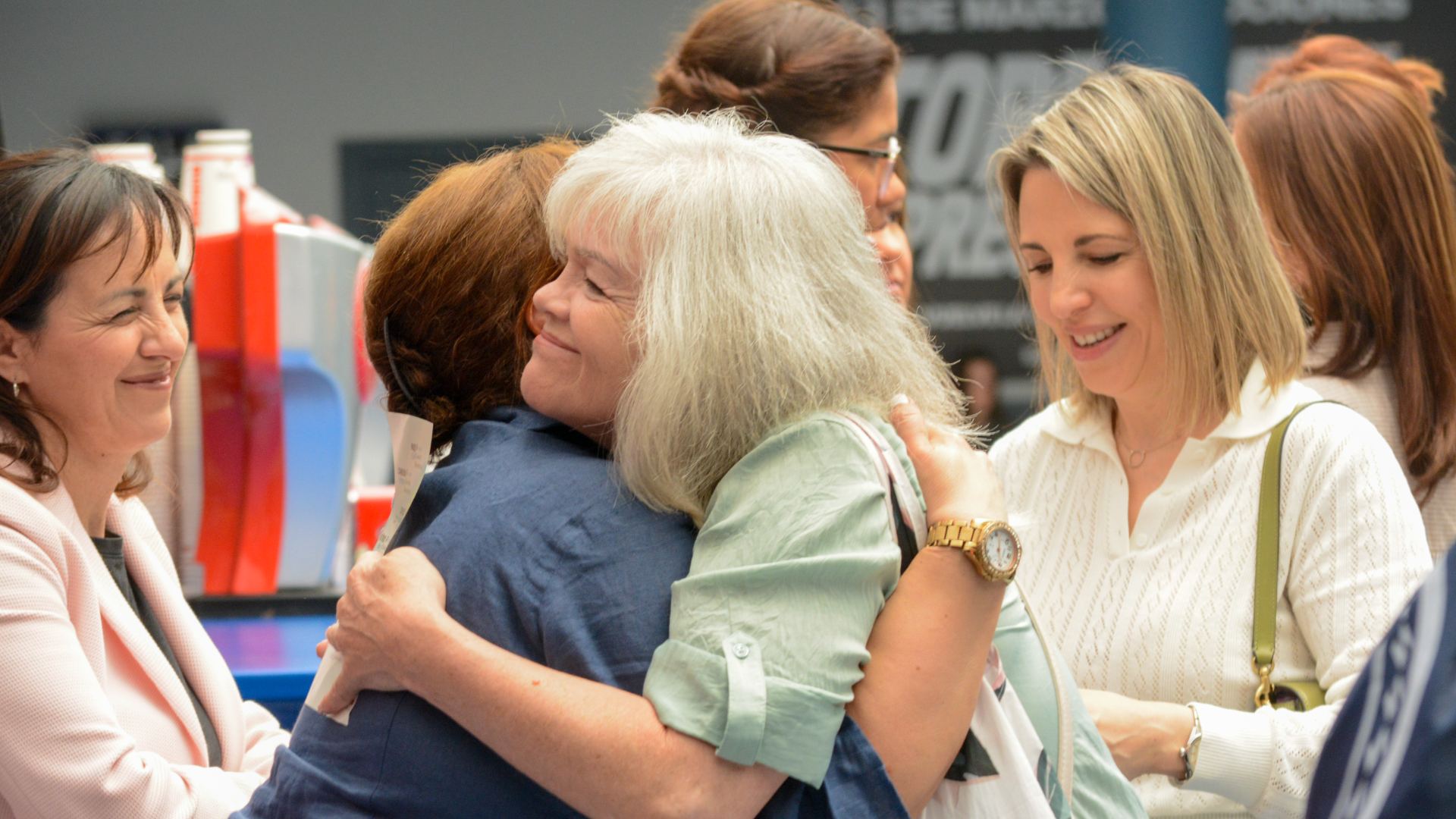 People hugging and smiling at a church gathering